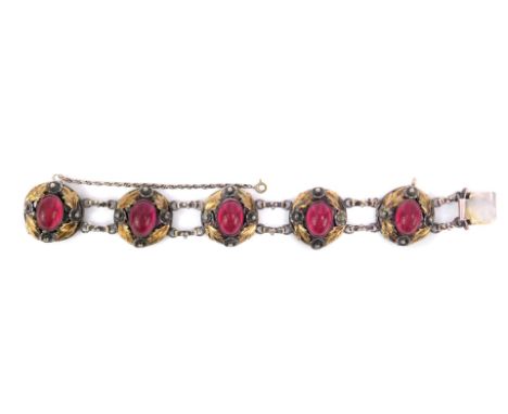 A Hobé floral bracelet, set with cabachon cut stones, with etched design to create the star effect, in leaf and floral border