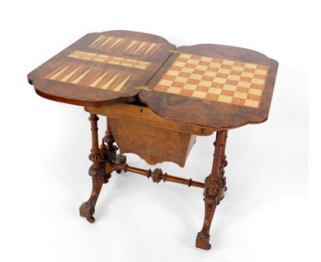 A Victorian walnut games and sewing table, with burr yew crossbanding to the hinged top opening to reveal a marquetry chess b