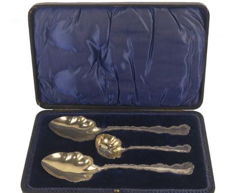 A pair of late Victorian silver serving spoons and matching sifting spoon, with scallop shaped silver gilt bowls and fancy sc