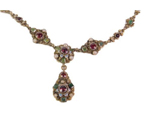 An Eastern style semi precious necklace, set with peridot, garnet and seed pearls, with pendant drop decorated with blue and 