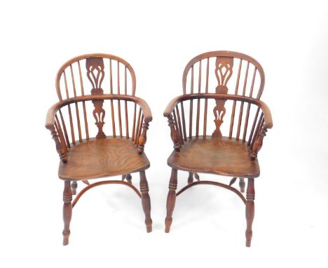 A pair of early 19thC yew wood low back Windsor chairs, with pierced splat, turned supports and triple ring turned legs with 
