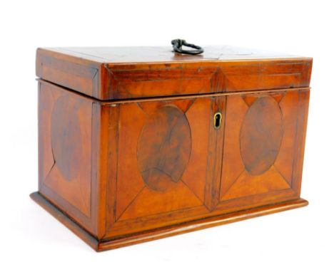 A George III cross banded mahogany rectangular tea caddy, decorated with quartered panels with central flame mahogany ovals, 
