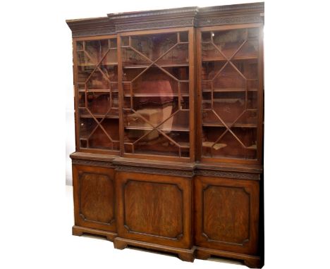 A 19thC mahogany breakfront cabinet bookcase in the Chippendale manner, with Greek key moulded cornice, blind fret frieze ove