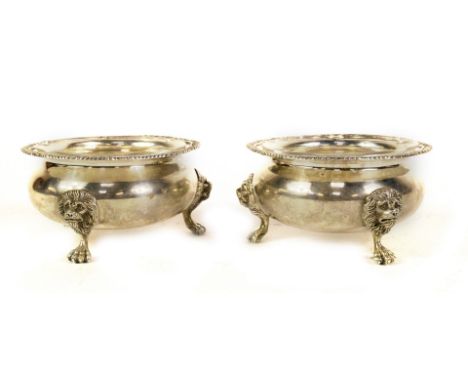 A pair of George V silver sugar bowls, in the form of a pair of large Georgian circular salts, with gadrooned shaped borders,