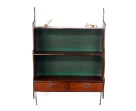 A George III mahogany hanging wall shelf rack, with three tiers having shaped sides and enclosed back, the lower tier with tw