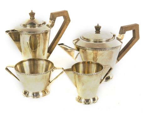 A late George V Art Deco silver four piece tea set, comprising teapot, hot water jug, milk jug and sugar basin, having tapere