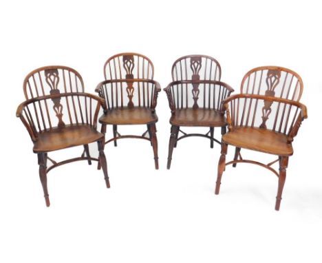 A harlequin set of four early 19thC yew wood Windsor chairs,  all with matching splat backs, three with turned supports, one 