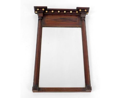 A small Regency mahogany pier glass by Hobster of Boston, with moulded and recessed pediment having ivory ball ornaments and 