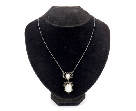 A mother of pearl and marquasite necklace, the pendant of drop form, with mother of pearl to each surrounded by marquasite, o