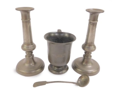 A 19thC pewter pint tankard, Victorian pewter cream ladle, and a pair of pewter candlesticks, 22.5cm H. (4)