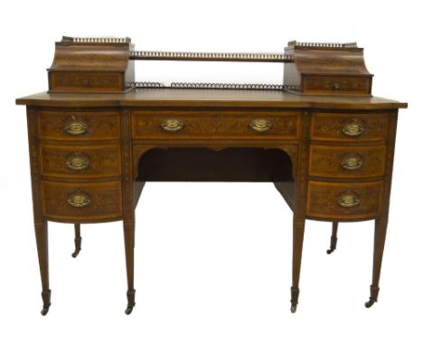 A late Victorian marquetry writing desk by Maple &amp; Co, having brass gallery top with cavetto lift flaps and fitted drawer