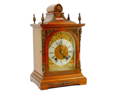 A Victorian walnut cased bracket clock, the brass arched dial with gilt rococo scroll spandrels, silvered chapter ring bearin