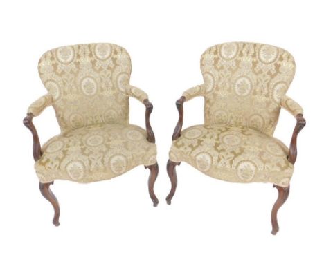 A pair of 18thC mahogany framed open armchairs, of Hepplewhite design in the French taste, with over stuffed backs and seats 