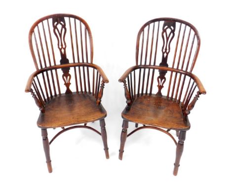 A pair of early 19thC yew wood Windsor chairs, with pierced splat, turned supports and single ring turned legs with crinoline