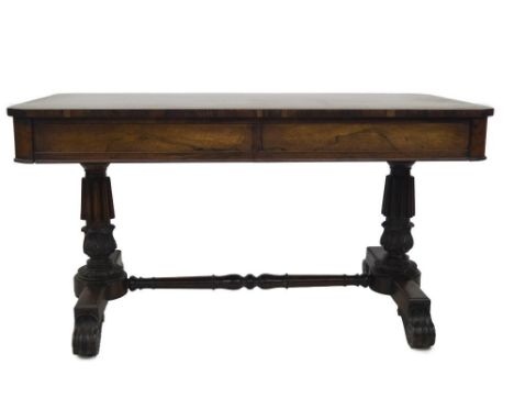 An early 19thC rosewood library table, with rounded rectangular top and two frieze drawers, one having the label MANUFACTURED