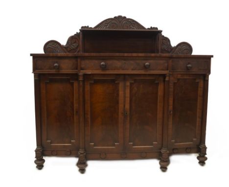 A Regency mahogany breakfront sideboard in the manner of Gillows of Lancaster, with floral stylised scroll back with single s