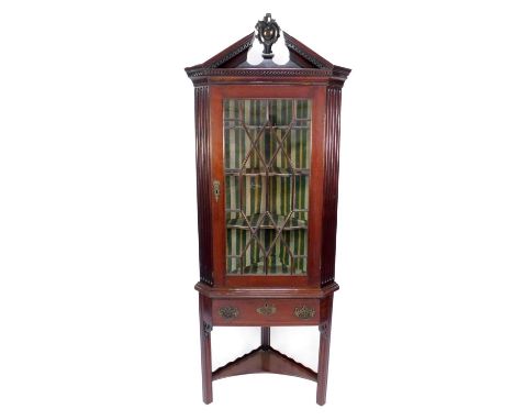 A George III mahogany standing corner cabinet with a broken arch Greek key moulded cornice, having central rococo cameo finia