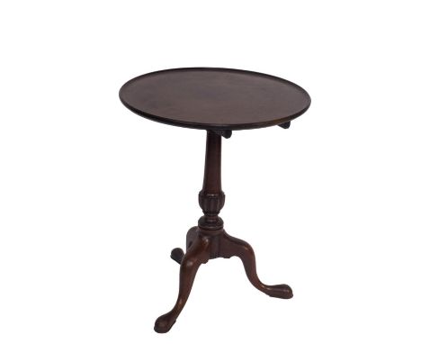 A George III mahogany supper table, with moulded dish top, baluster stem with reeded bulb, on three cabriole legs with pad fe