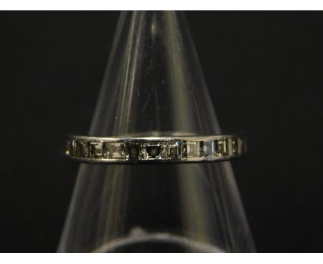 A diamond eternity ring, set with thirty one square cut diamonds, each stone approx 6pts, totalling approx 1.86cts, in rub ov