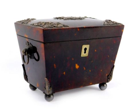 A Victorian tortoiseshell sarcophagus tea caddy, with embossed silver mounts and pair of ring and ball handles, the hinged li