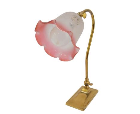 A Christopher Wray Victorian style brass angle poise table lamp, with a frosted clear to cranberry glass shade, 35cm H.