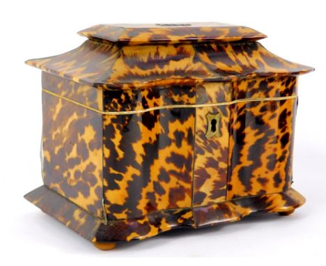A Regency serpentine fronted blonde tortoiseshell tea caddy, the stepped and flanged lid opening to reveal twin lidded compar