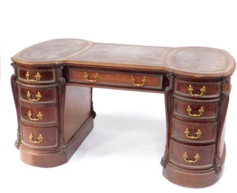 A fine late 19thC carved mahogany hour glass partner's desk in the manner of Wright &amp; Mansfield, with three inset tooled 