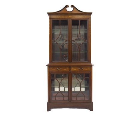 A  late 19thC Maple &amp; Co display cabinet in the Sheraton manner, with shell inlaid swan neck pediment, floral scrolling f