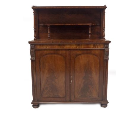 A William IV flame mahogany chiffonier in the manner of Gillows of Lancaster, with double shelved back, on baluster turned su