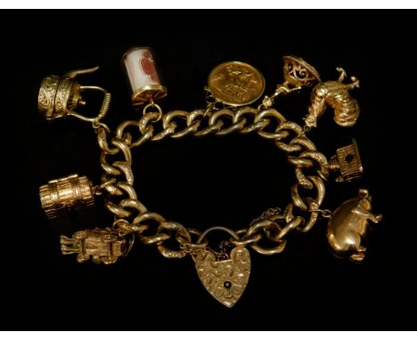 A 9ct gold charm bracelet, with a variety of 9ct gold charms including cart, treasure chest, 10 shilling note scroll, kettle,