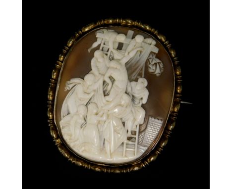 A late 19thC shell cameo brooch, depicting a group of females lifting a male to the cross, in a gilt metal frame, with 9ct sa