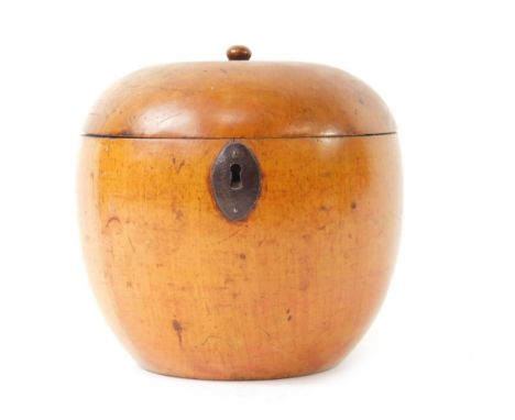 A George III turned fruitwood apple shape tea caddy, with stalk knop to the hinged lid and iron escutcheon plate, 11.5cm H.