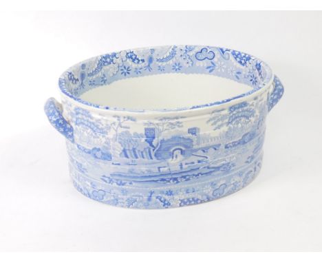 An early 19thC Spode pearl ware blue and white foot bath, transfer decorated in the Tudor pattern, printed marks, 48cm W.