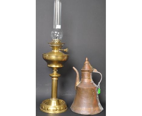 An early 20th century brass Juno oil lamp with glass funnel, together with a large copper Persian style Dallah coffee pot. Me