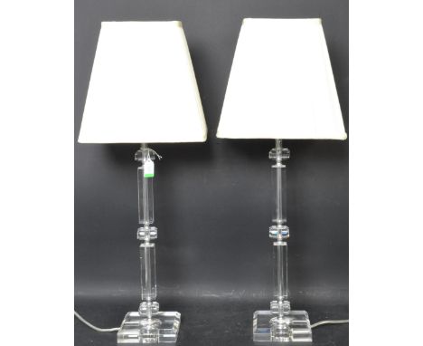 Two retro vintage style clear acrylic light shades having a square supports raised on a stepped base. Measures approx. 72cm h
