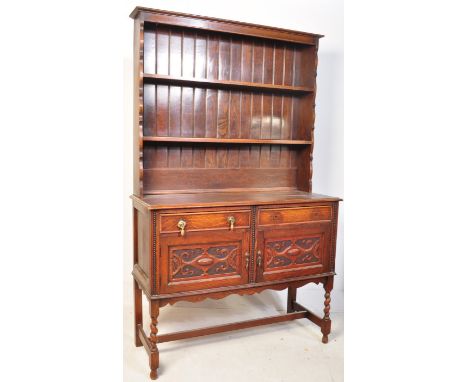 A vintage Georgian circa 1940's oak sideboard / dresser. The raised back having two shelves atop a rectangular form base with