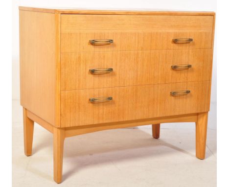 A retro vintage mid 20th Century circa 1960's oak chest of drawers. The drawers of a rectangular form having a bank of three 