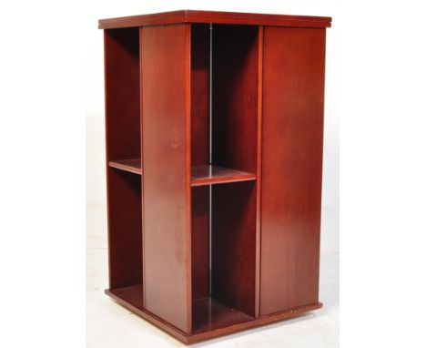 A vintage early 20th century mahogany revolving library bookcase. The bookshelf having inlaid maple wood details to the top a