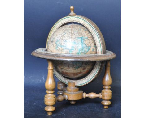 A vintage 20th century wooden colonial Latin desk globe having papered map to globe and zodiac illustrations to the frame, ra