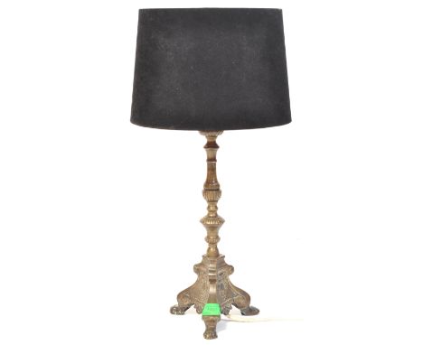 A vintage 18th century style gilt table lamp having scrolled decoration raised on a tripod base. The lamp having a taping met