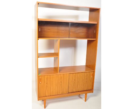 A retro vintage mid 20th century room divider wall unit / bookcase having an arrangement of shelves, glazed sliding door book