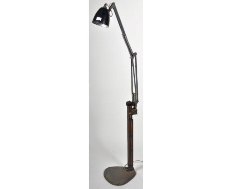 A retro vintage mid 20th Century industrial floor standing work lamp comprising of a black enamel conical pendant shade raise