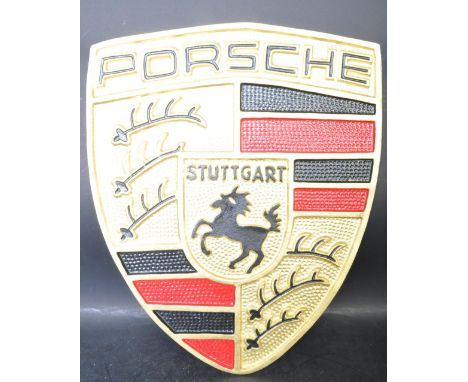 A large vintage style cast metal point of sale / advertising Porsche armorial shaped plaque / shield featuring the iconic rea