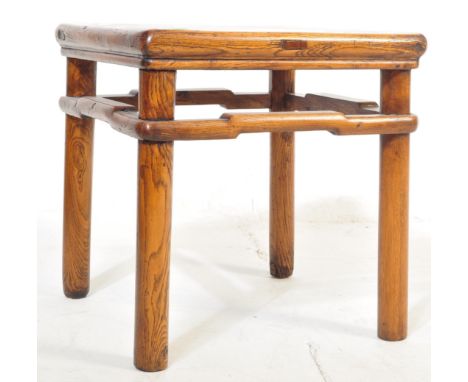 An early 20th century Chinese elm side console occasional table having circular block supports united by shaped stretchers. M