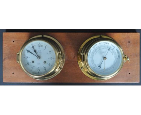 A vintage 20th century Schatz brass bound twin ships clock and barometer / compendium. Both having enamelled faces with black