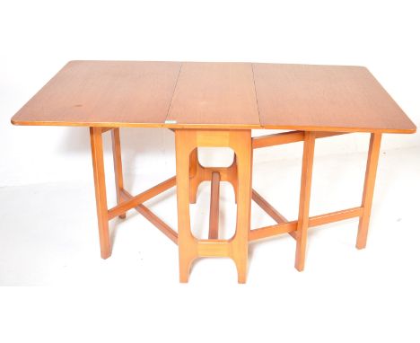 A retro vintage mid 20th century circa. 1970's teak wood extendable dining table having two drop leaves and base consisting o