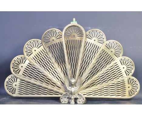 An Art Deco style 20th century gilt brass articulated peacock fireguard having pierced decoration and held together with hook