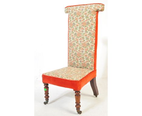 A Victorian 19th century prie dieu nursing chair. Raised on turned mahogany legs with castors having overstuffed tapestry sea