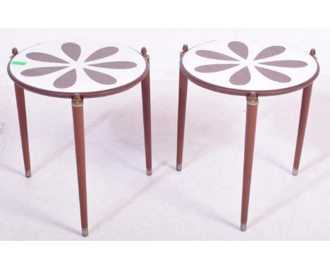 A pair of retro vintage mid 20th Century side/occasional tables. The tables having a circular top with floral/petal decoratio