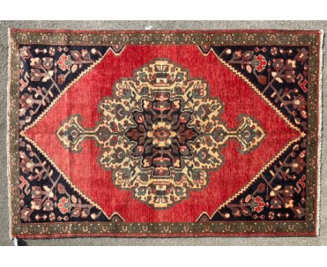 An early 20th century hand knotted Persian Islamic Bakhtiar floor rug carpet. The rug having a central beige and dark medalli